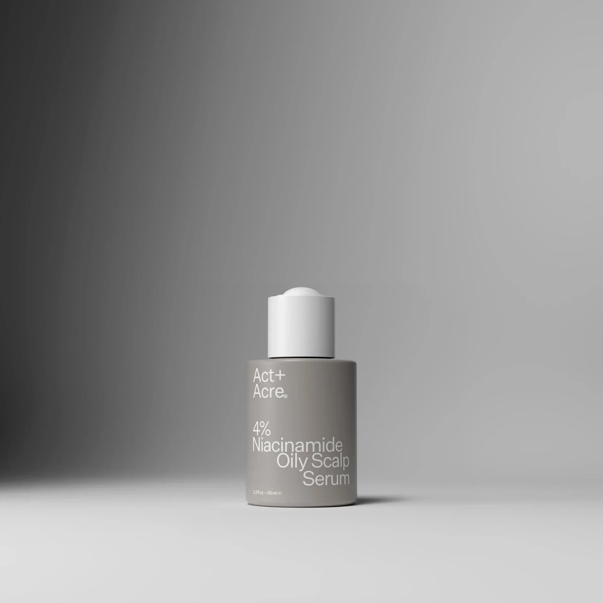 A skincare serum bottle labeled 'Act+ Acre Niacinamide Oily Scalp Serum' with a gray to white gradient background.