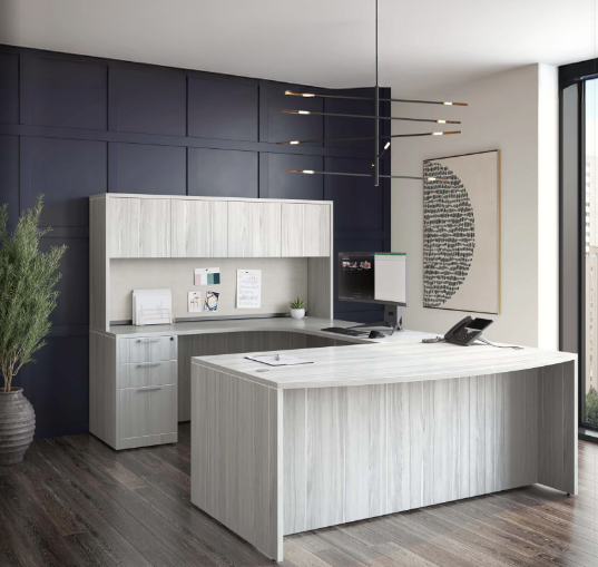 Modern office with white wood desk and cabinet, dark blue accent wall, abstract art, and large window.