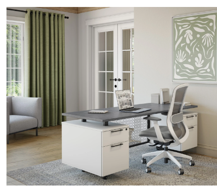 Home office with white desk, ergonomic chair, laptop, and decor, including a green curtain, framed artwork, and windows.