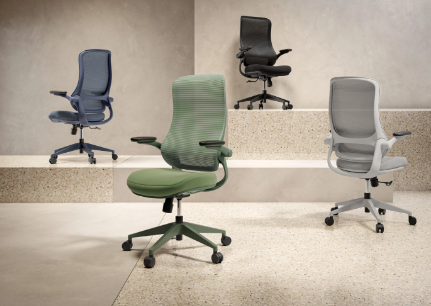 Four office chairs in various colors arranged on a concrete step.
