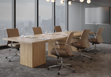 Empty modern conference room with a large wooden table, six beige office chairs, large windows with city views, and a mounted display screen.