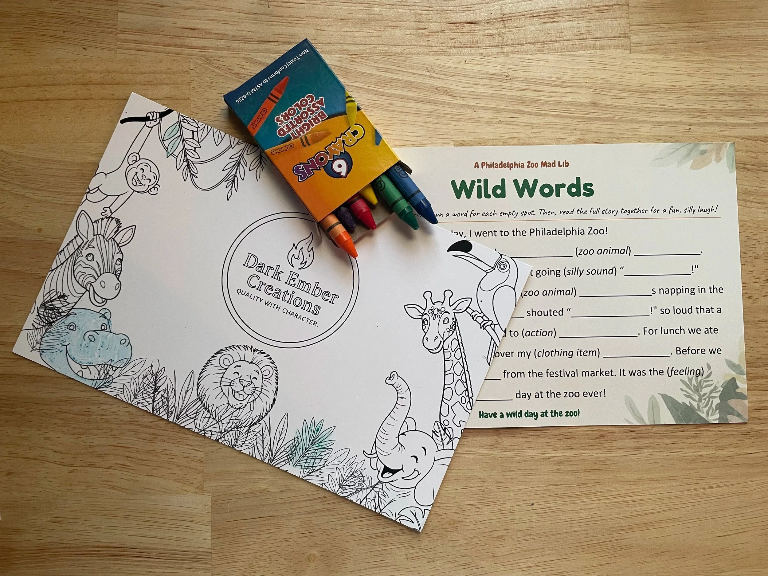 Coloring sheet and madlib with crayons on a table