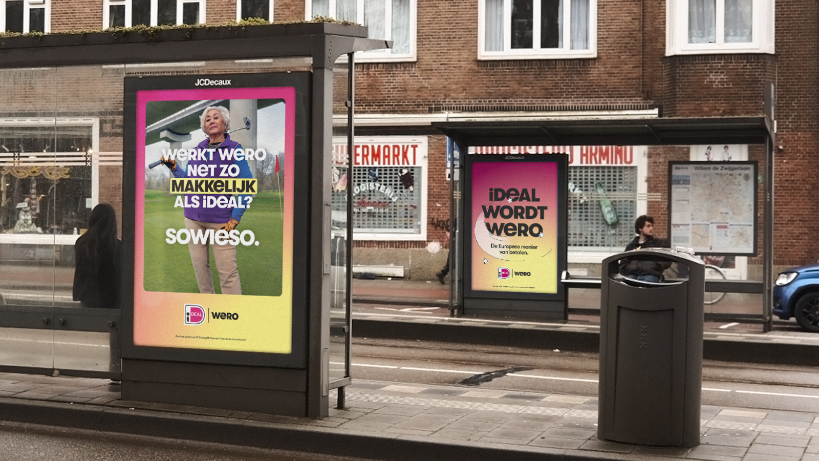 Bus stop with two advertisements, one featuring an elderly woman with gray hair holding a golf club, and the other with colorful text for the launch of the Wero brand, in a city street with brick buildings and people waiting.