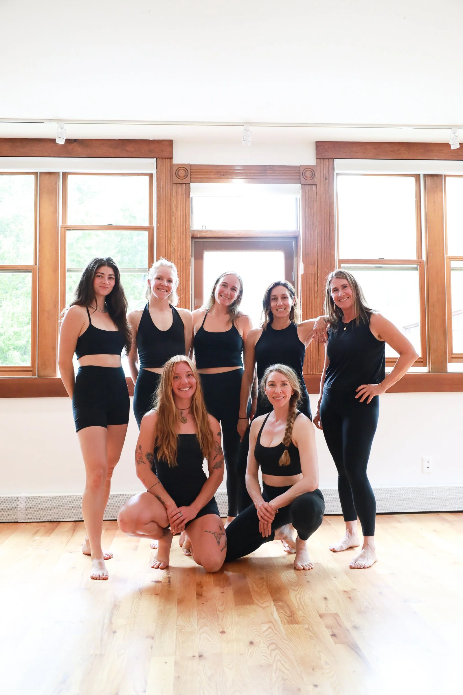 Range yoga instructors smiling in our sunny Telluride studio with large windows and lots of natural lights