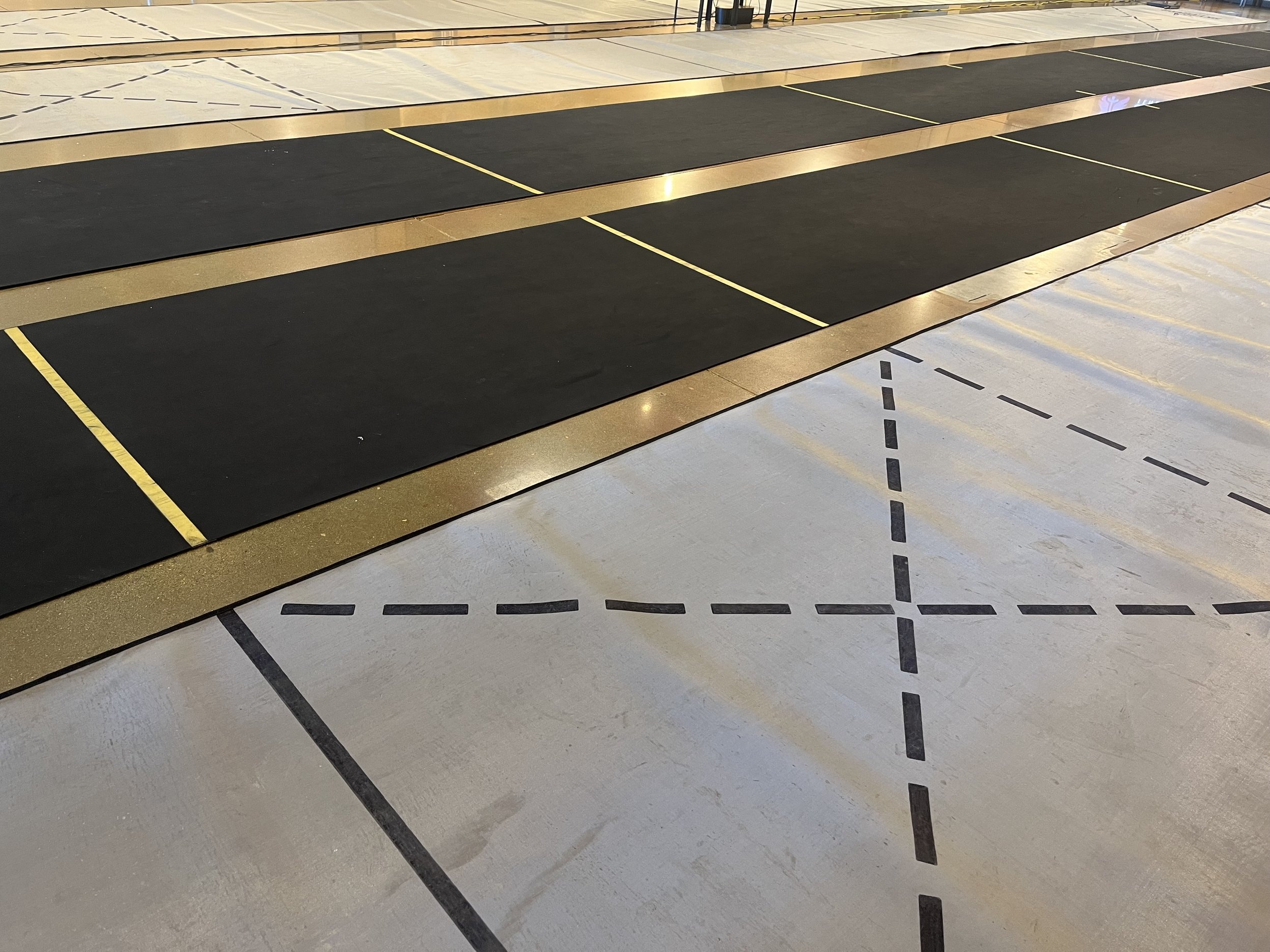 Multiple fencing pistes lined up next to each other