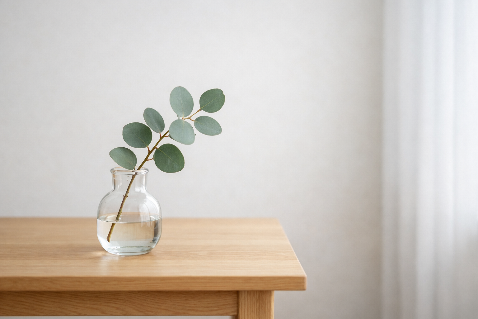 A peaceful, clutter-free table surface with a small botanical vase, styled by Home Clarity Decluttering in Ripon.