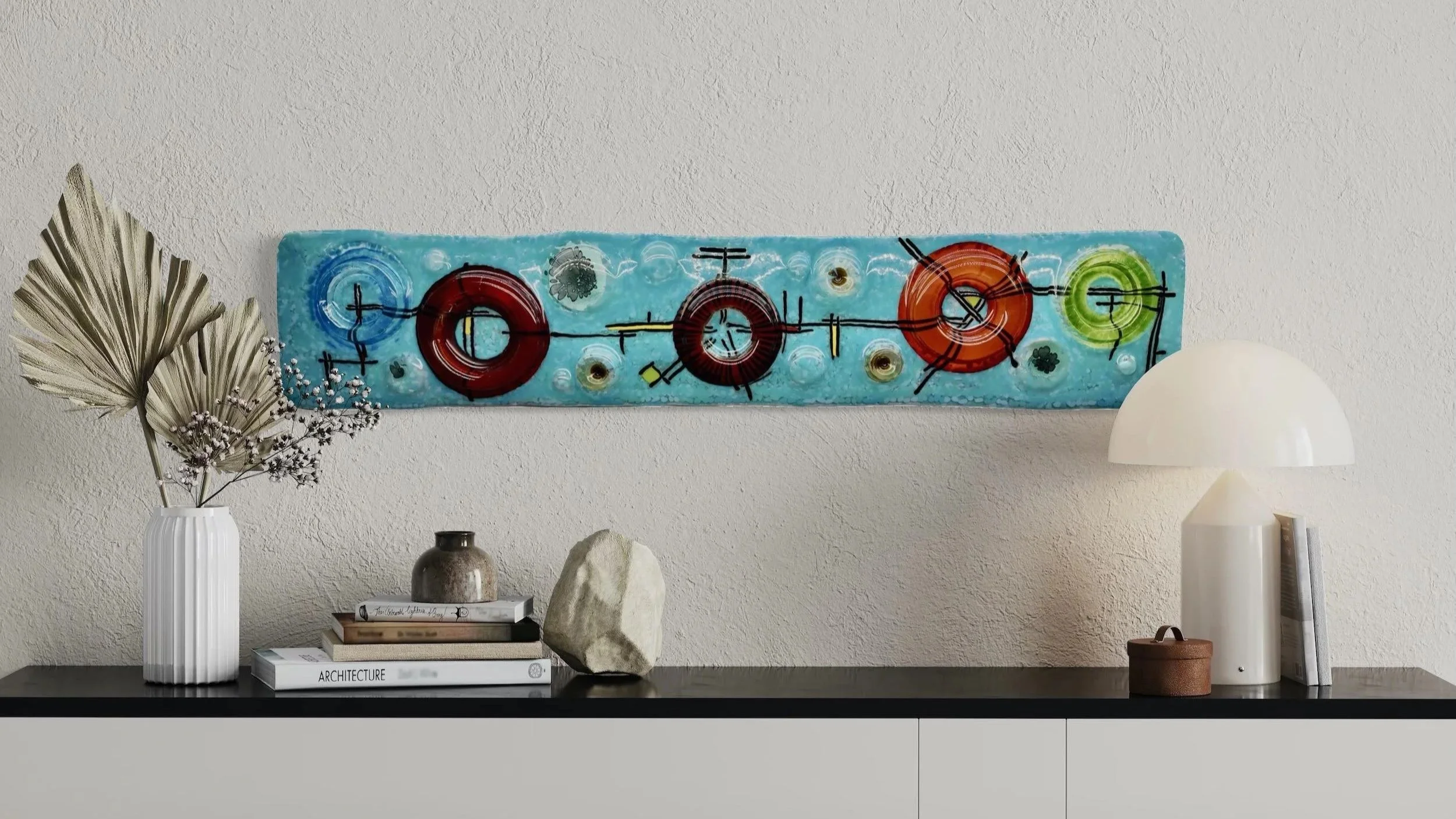 Custom 1970s Space Race theme 3D fused glass wall sculpture by Gina Word installed in a contemporary residential foyer.