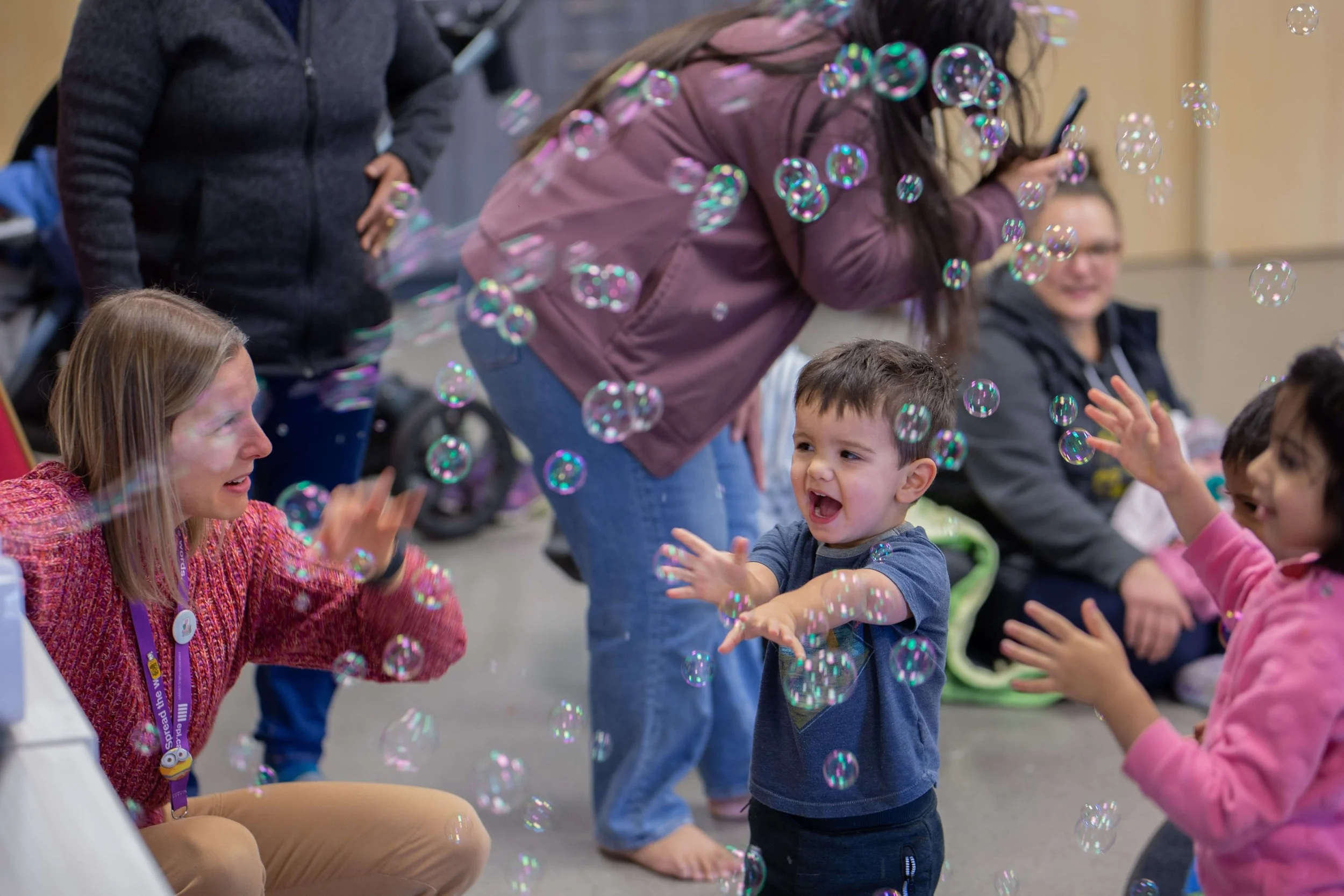 kids and adult playing with bubbles