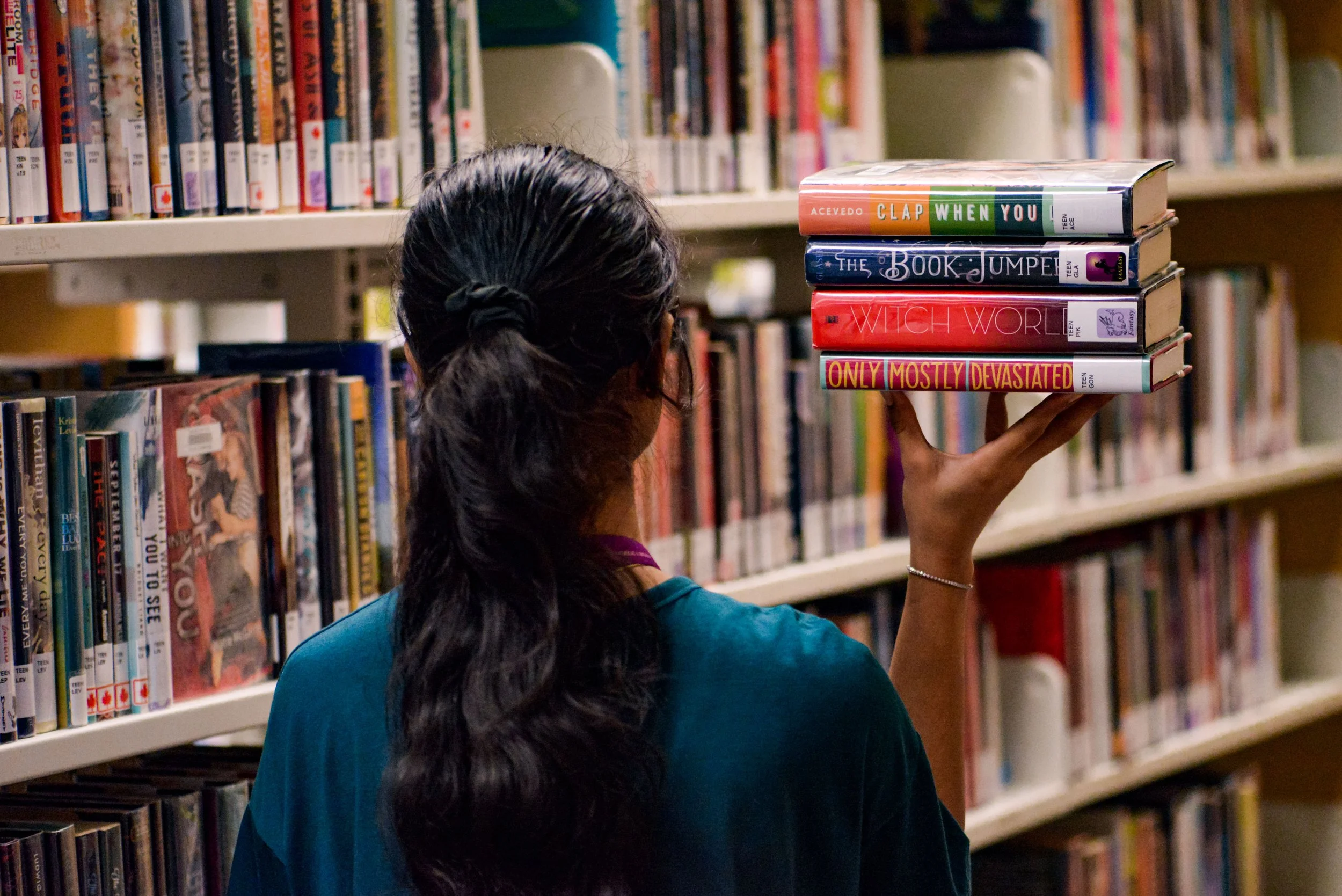A lady holding a number of books