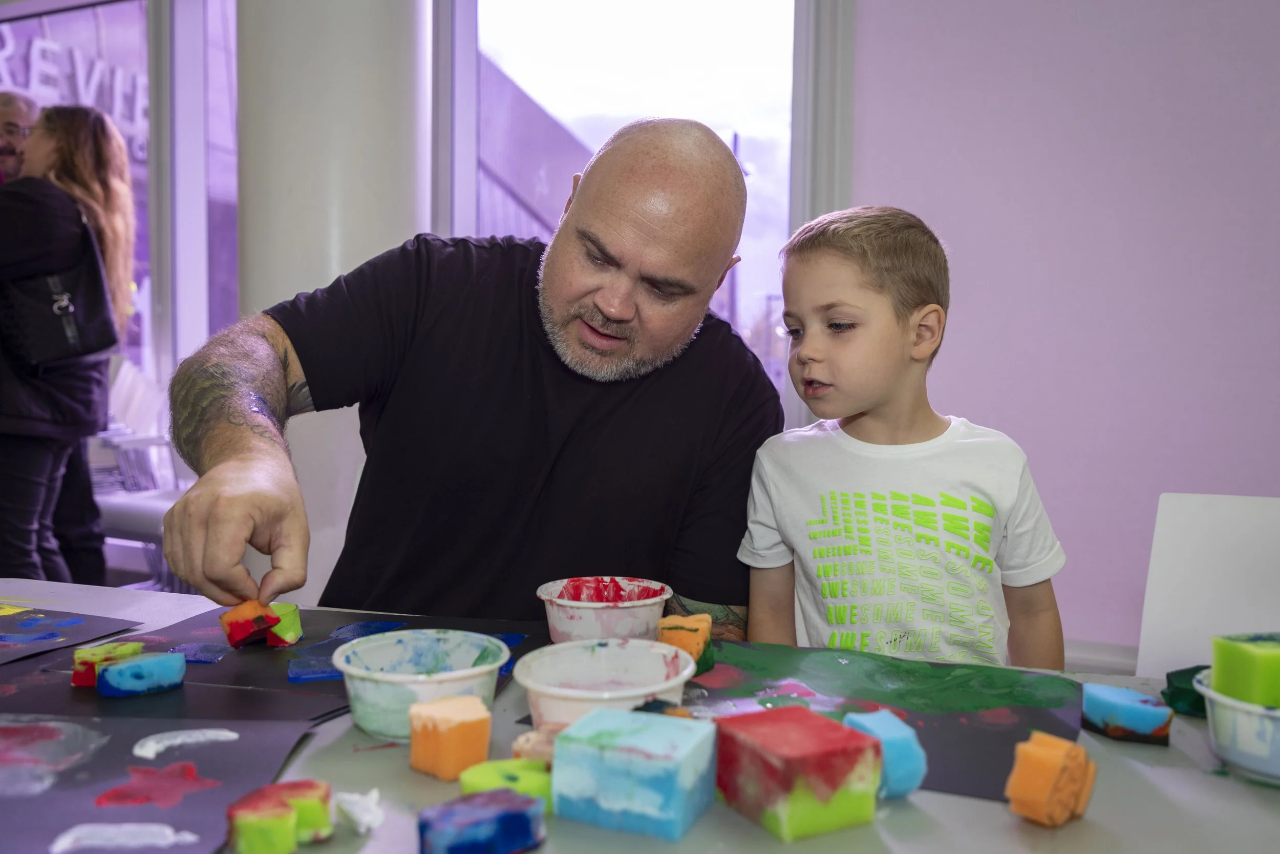 A man and a child painting together
