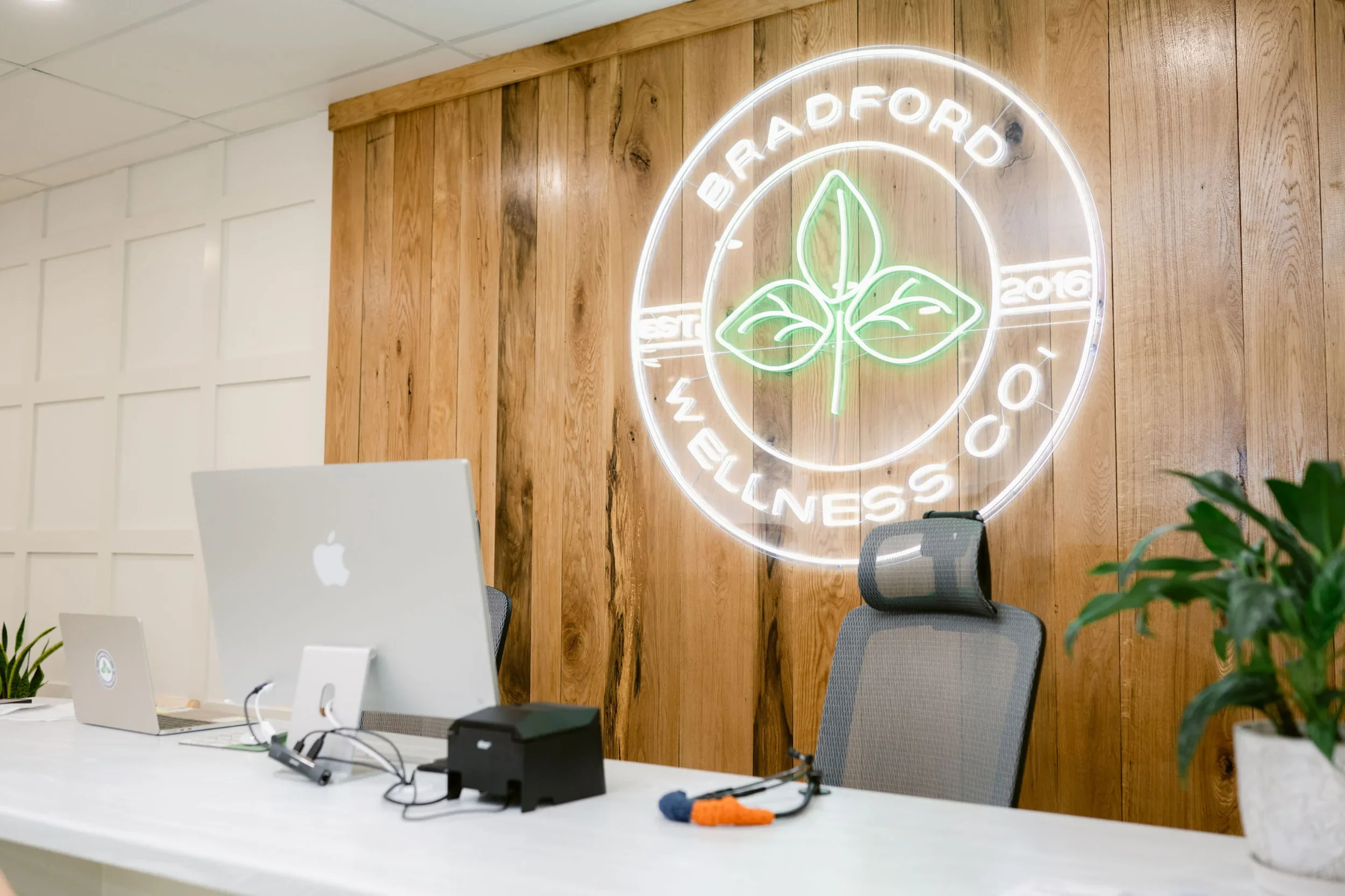 Functional medicine in Scottsboro, AL office space with a white desk, Apple MacBook, and office chairs.