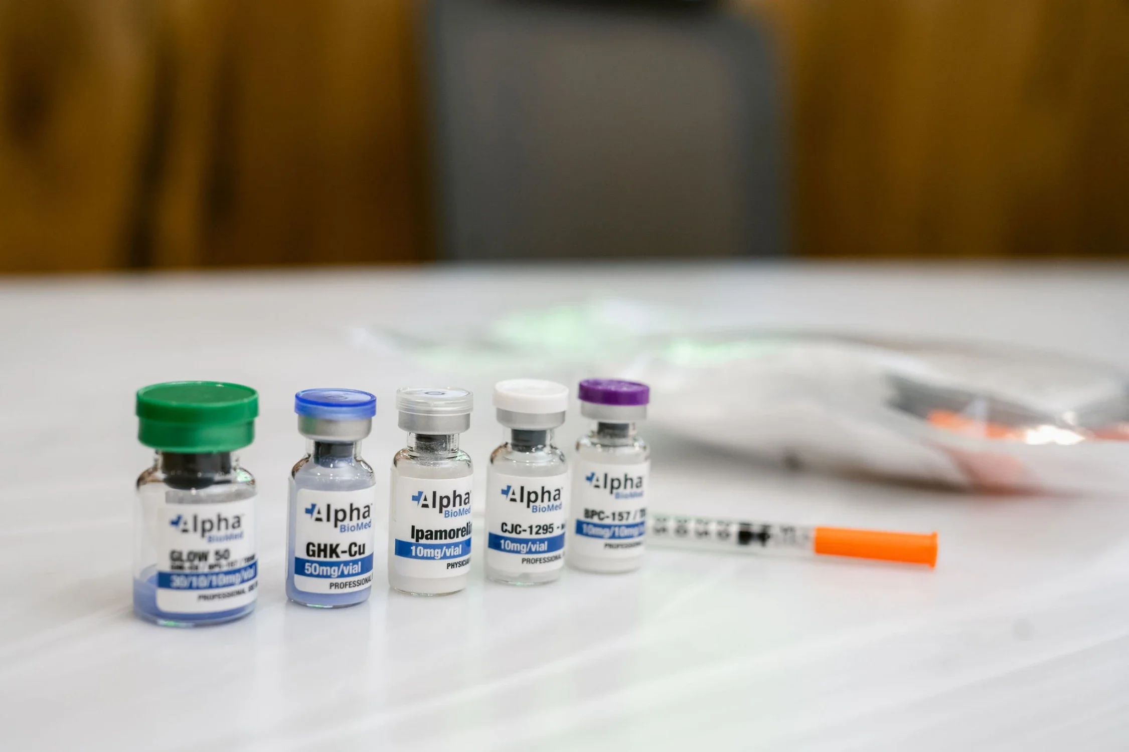 Peptide therapy in Scottsboro, AL shown on a white surface, with blurred brown and gray background.