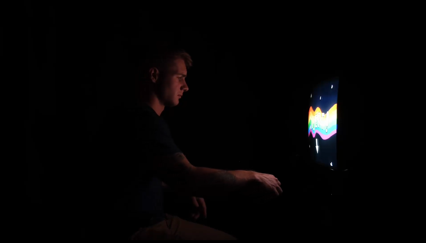 The base plate footage for "Static" showing a young man with blonde hair and tattoos on his arm sitting in darkness, focusing on a colorful, rainbow-themed image on a CRT TV screen.