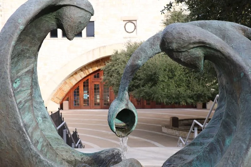Bronze sculpture framing the courtyard entrance at Riverbend Centre for the Arts