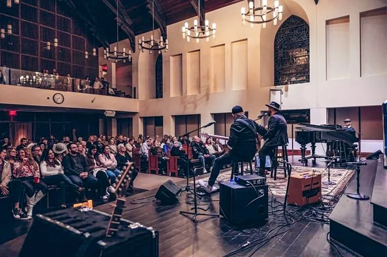 Live band performing for a seated audience at Riverbend Centre for the Arts