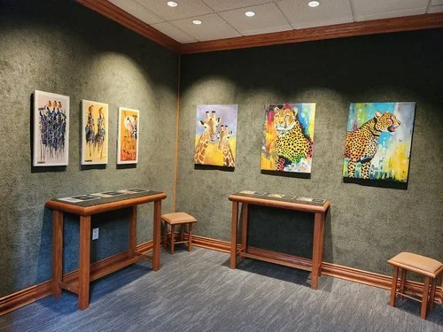 Student drawings and paintings presented throughout the exhibition hall