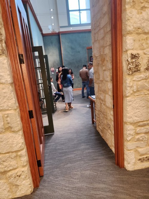 isitors walking through the exhibition hall and viewing student art