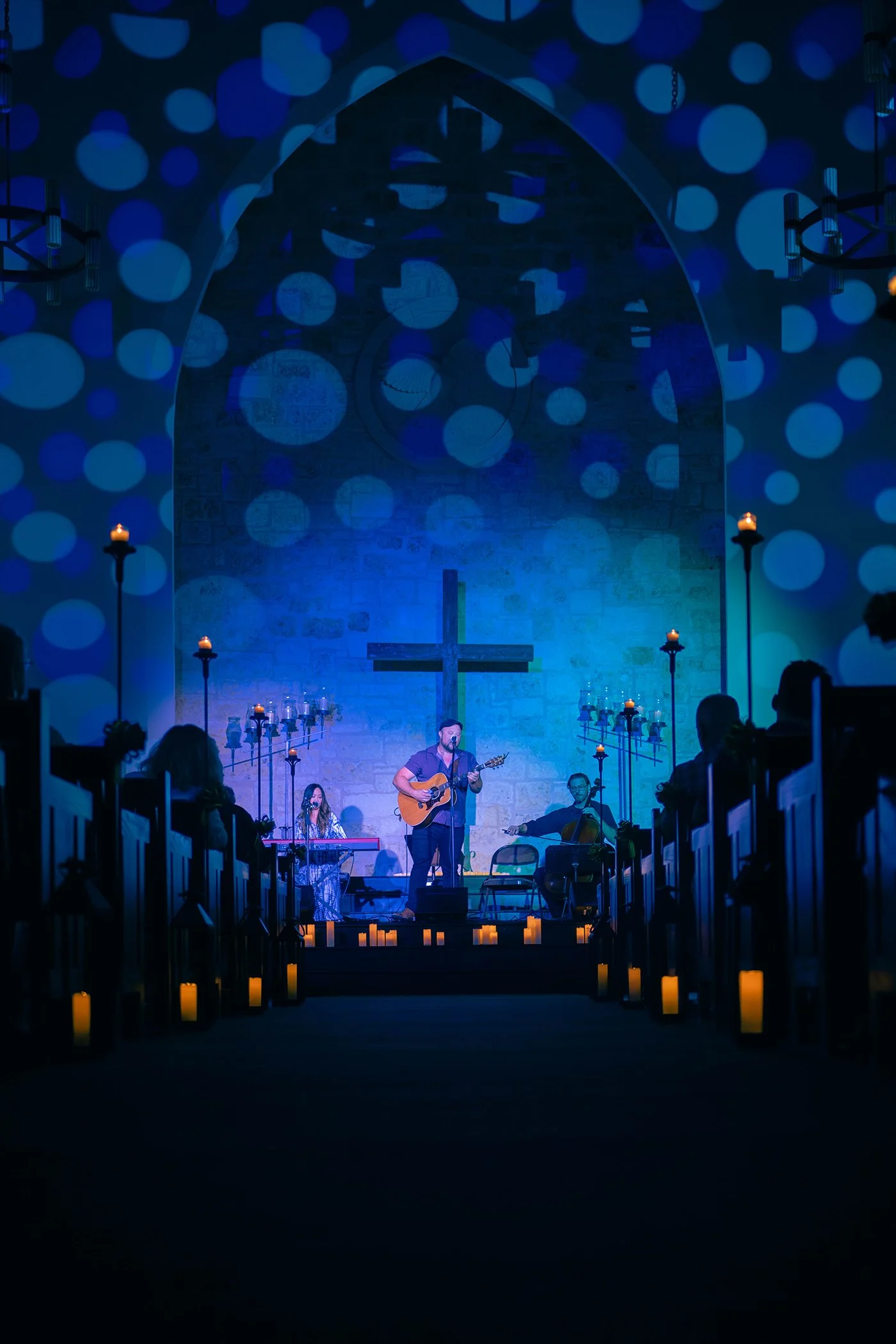 Performer on the Riverbend Centre stage beneath blue lighting