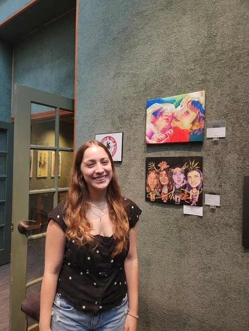 Student artists gathering beside their work at the Student Exhibition 2026