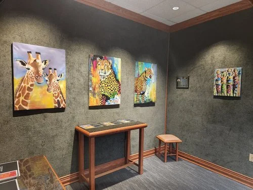 Wide gallery-wall display featuring works by student artists