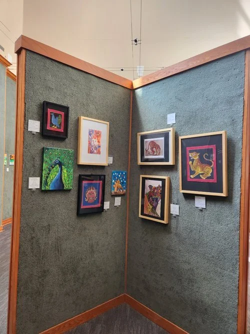 Framed student artwork displayed in rows at the Student Exhibition 2026