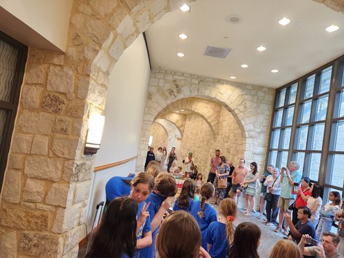 Visitors viewing student artwork displayed throughout the Riverbend gallery
