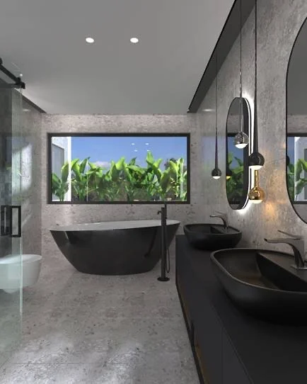 Modern bathroom with concrete walls and floor, a large window with garden view, black bathtub, black sink basins, and hanging pendant lights.