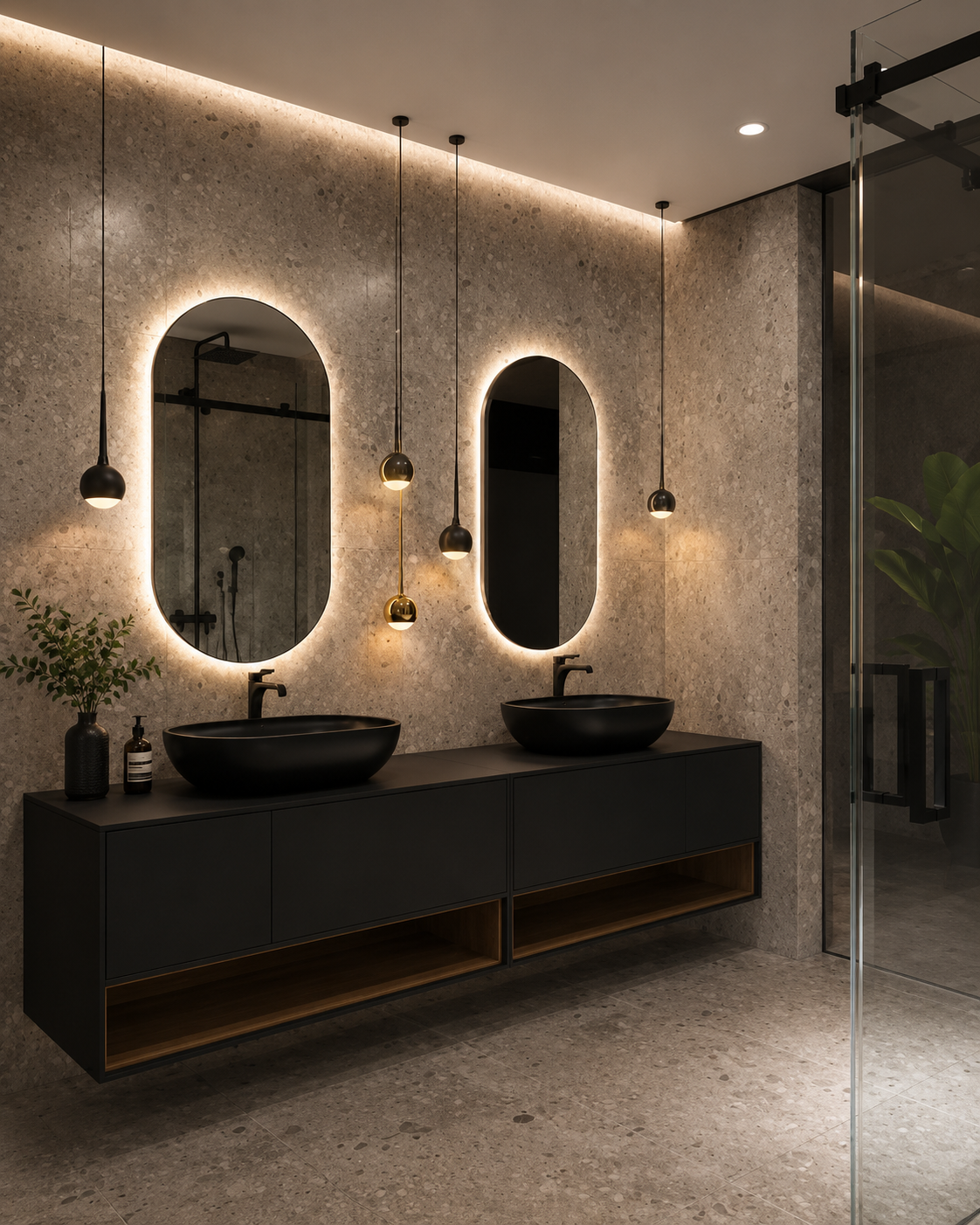 Modern bathroom with two black vessel sinks on a black cabinet, illuminated oval mirrors with backlighting, pendant lights, and a glass shower enclosure.