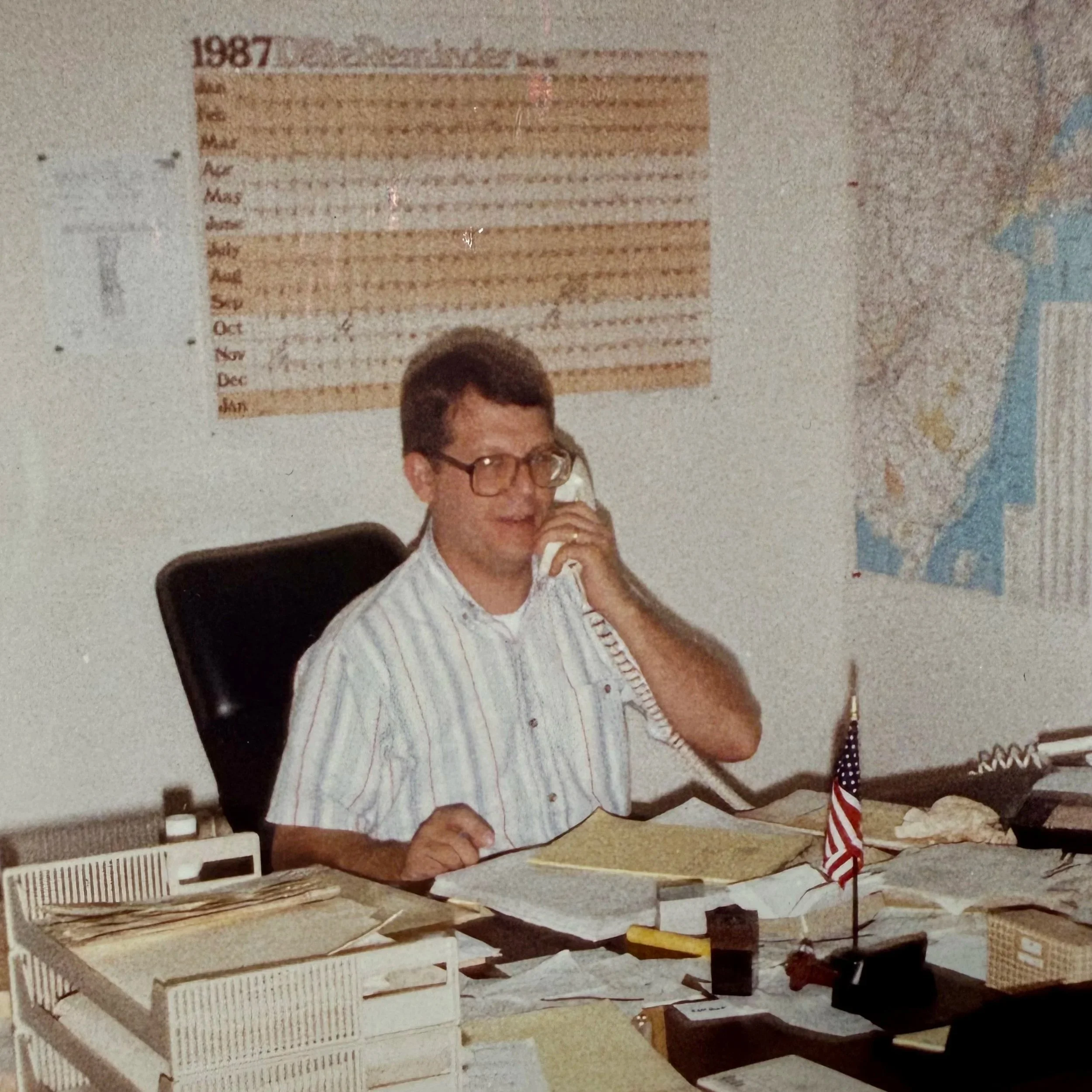 Photo of Willie Albert Founder of Nassau Transportation Working at His Desk Circa 1987