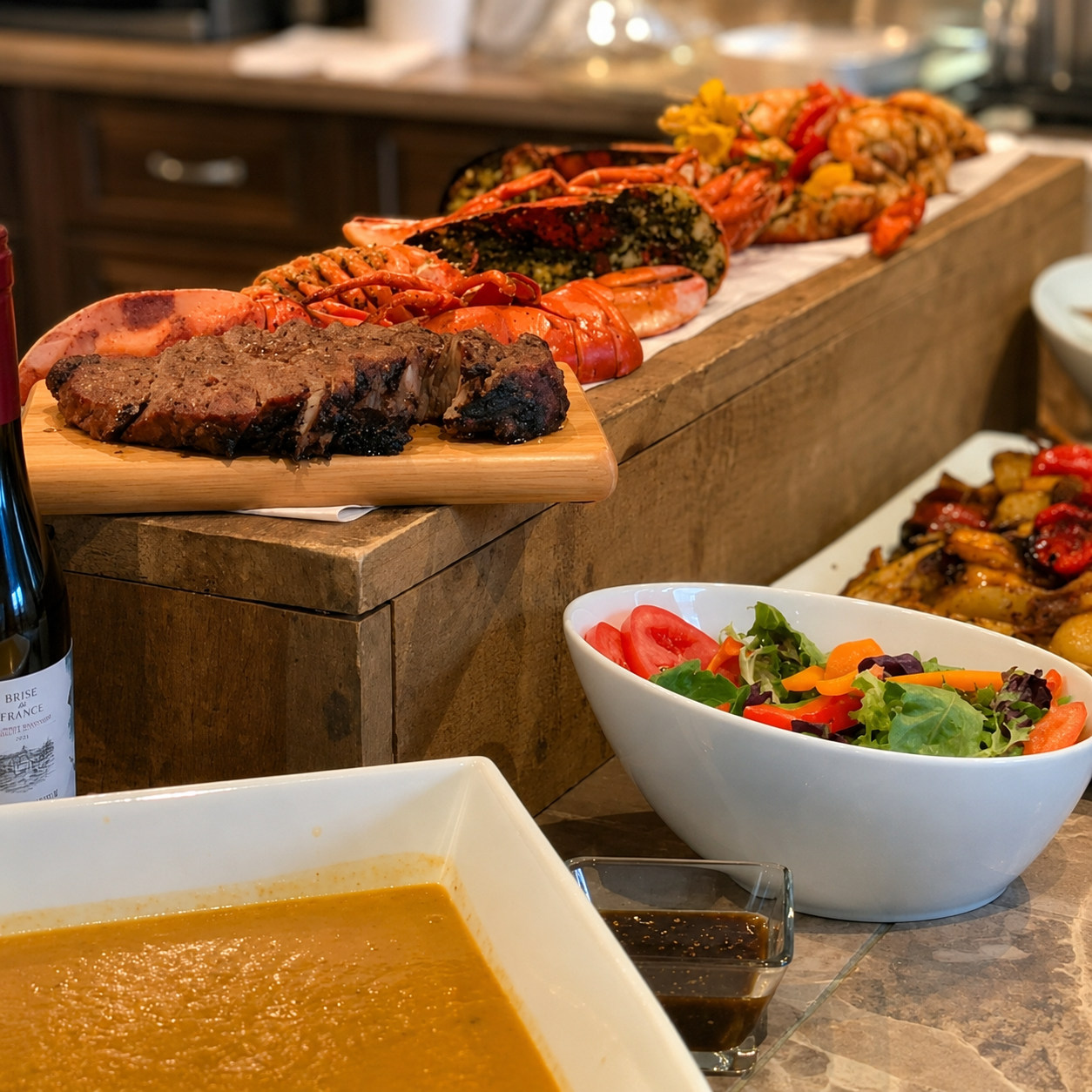 An assortment of cooked seafood, steak, and side salads on a buffet table, with a bowl of salad with tomatoes and greens in the foreground.