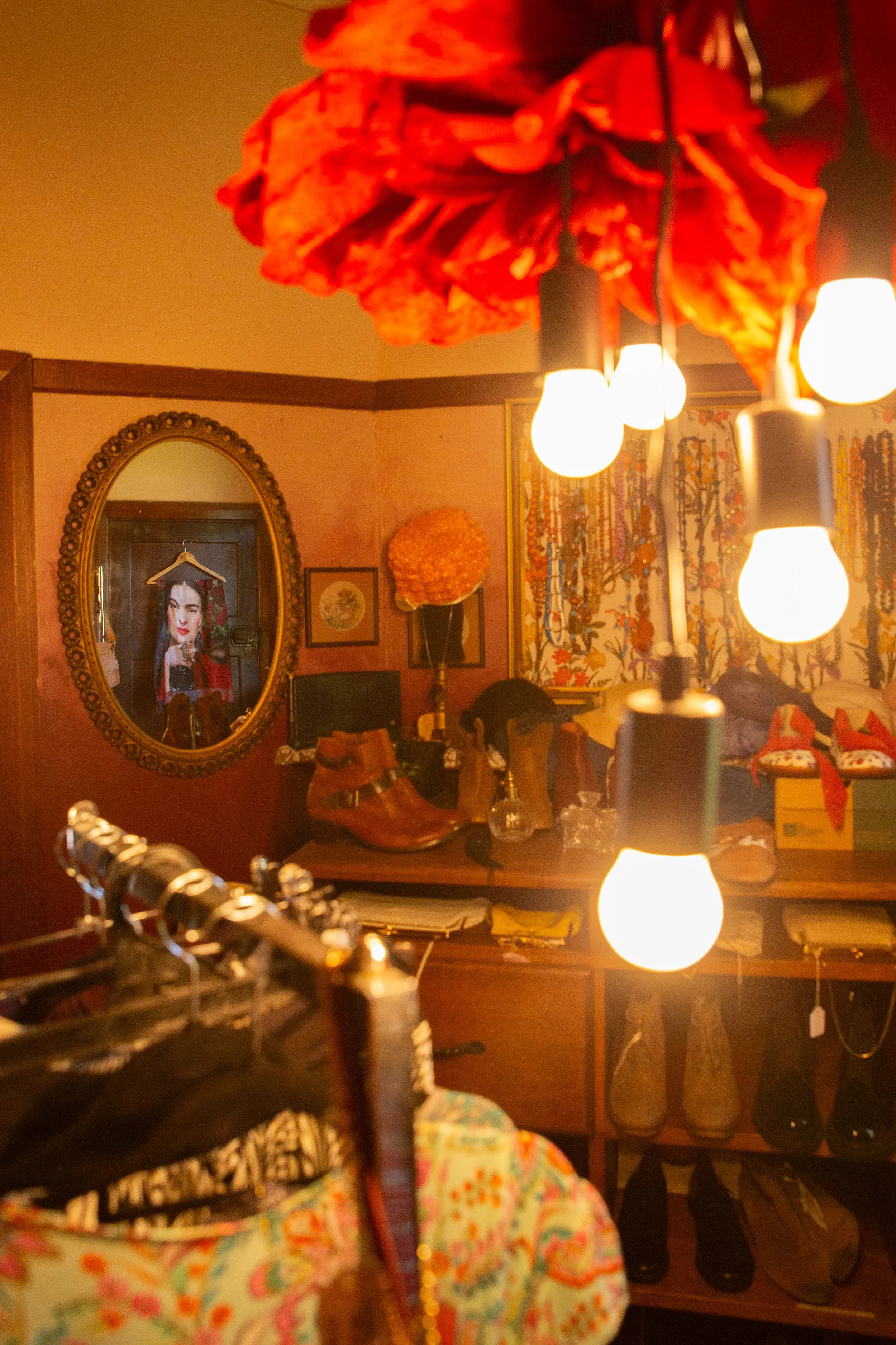 Ecclectic vintage shop with shoes, clothes, hats and moody lighting.