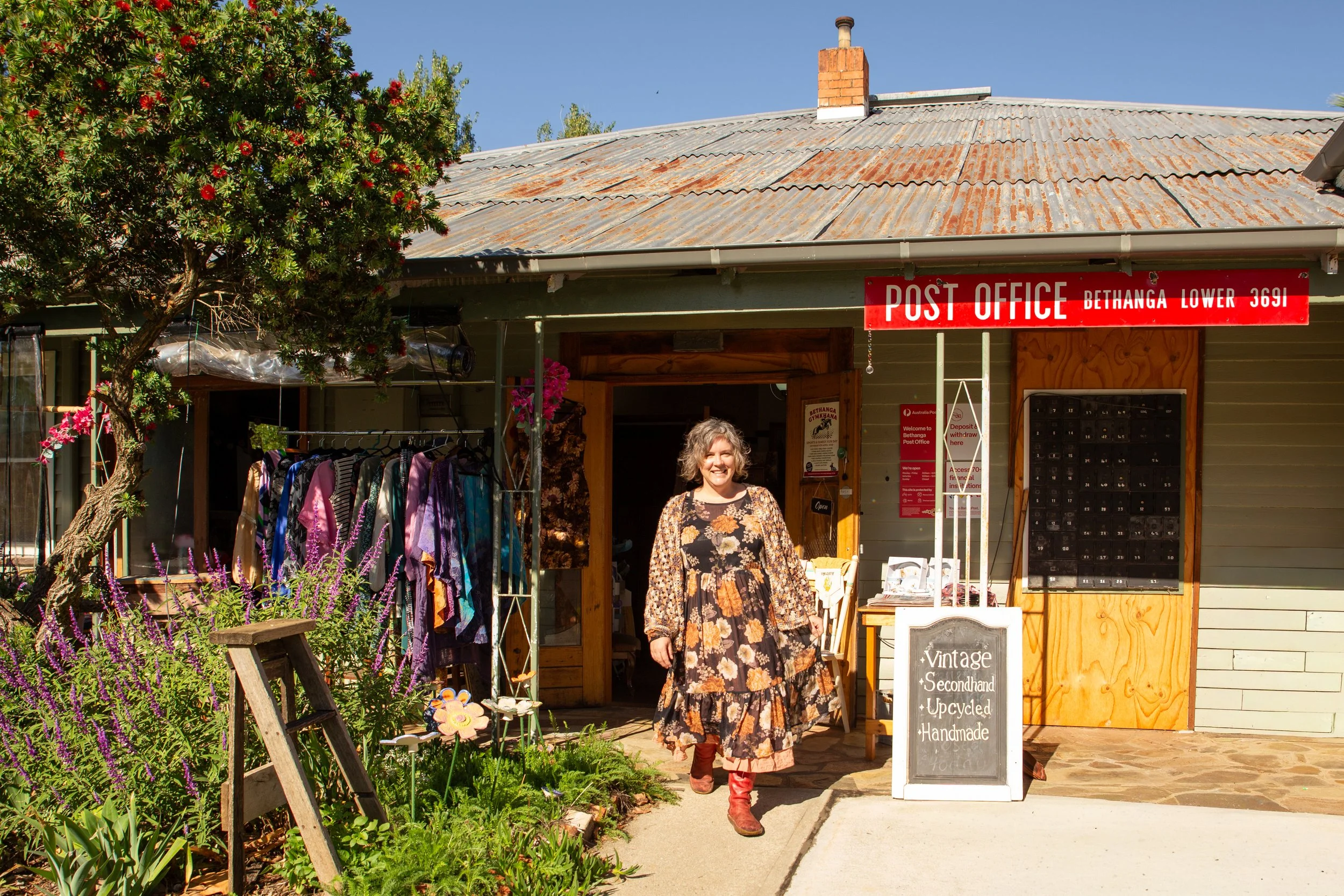 Woman walks towards camera in front of ecclectic vintage store.
