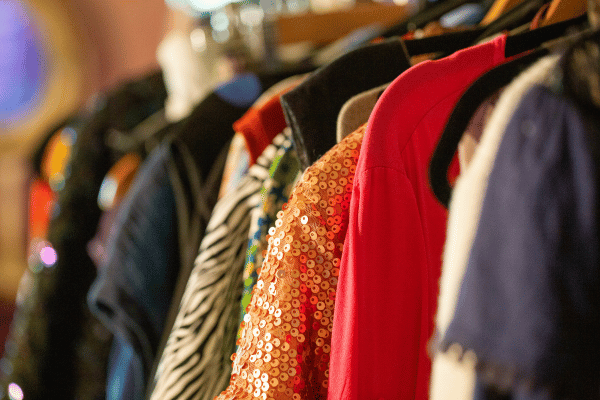 A rack of colourful vintage clothes.