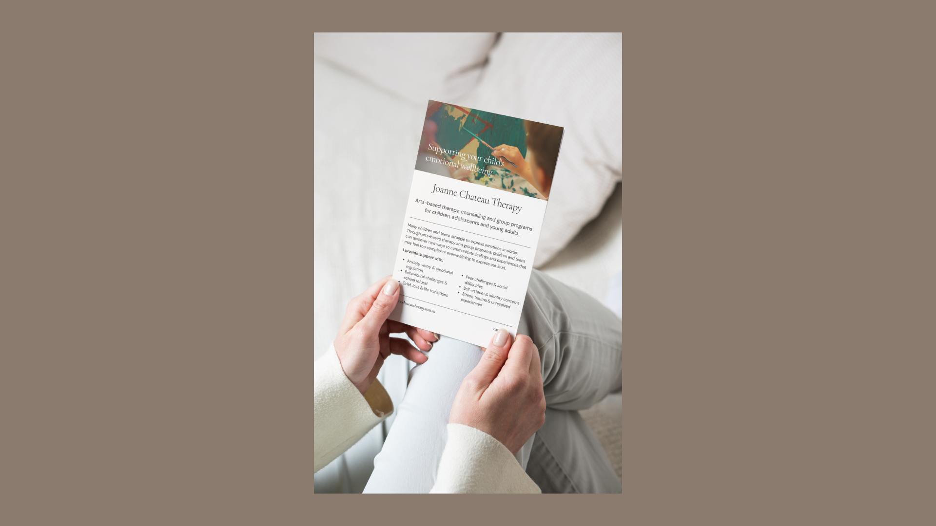 Person holding a printed flyer for Joanne Chateau Therapy, arts-based counselling for children, adolescents and young adults — print design by ovio