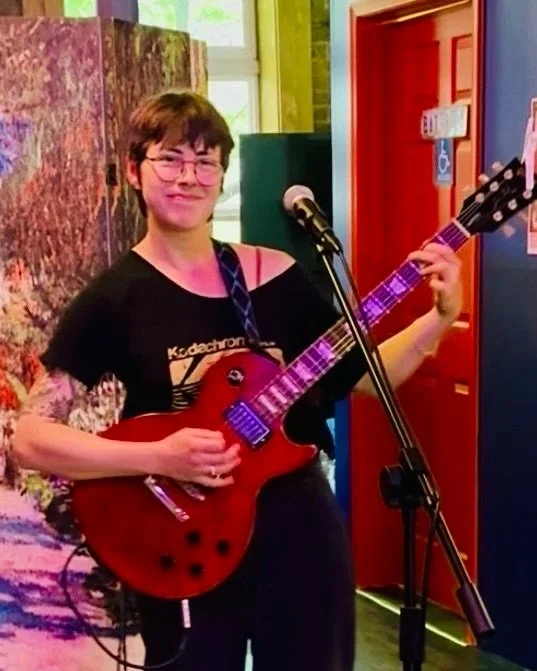 Mount Pom performing on guitar at the chicago market gallery