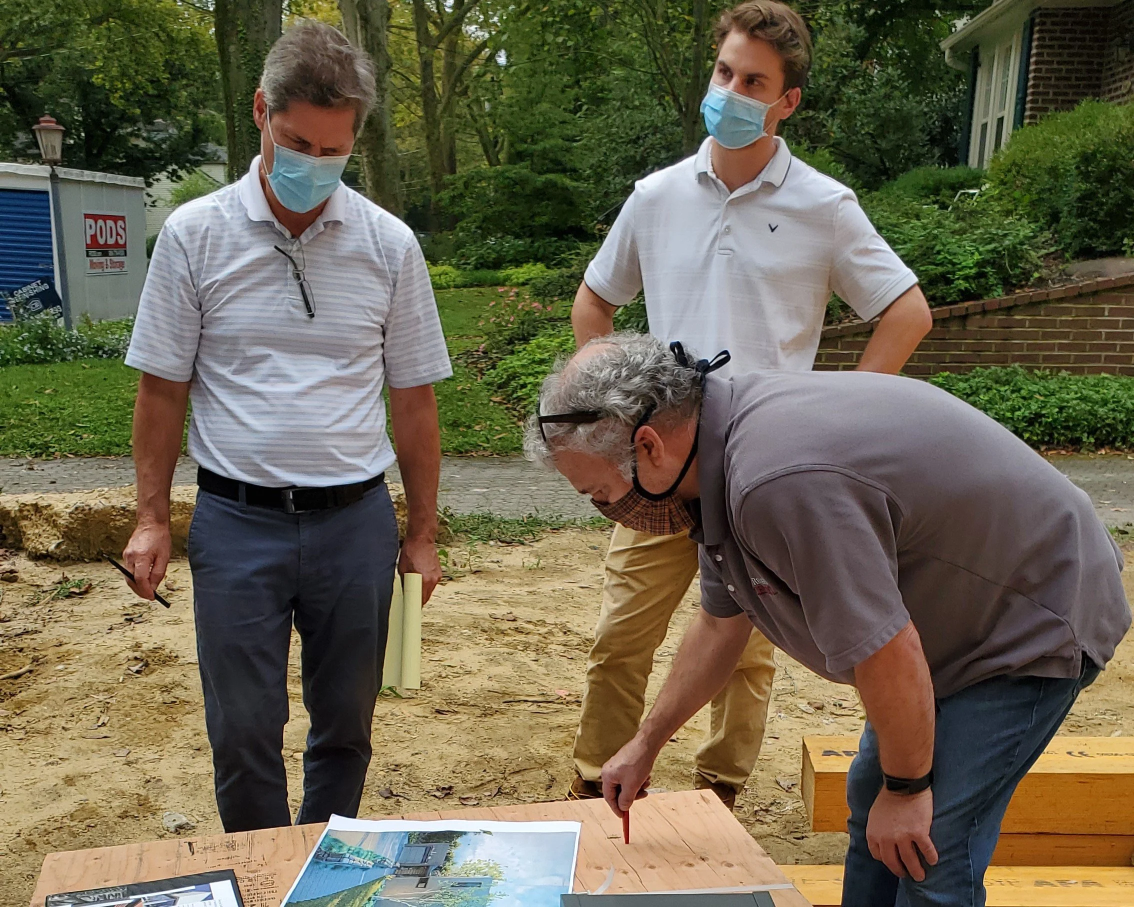 J Reinert Architecture reviewing construction progress and coordinating details on-site during the construction of Hadro House in Haddonfield, New Jersey during COVID-19