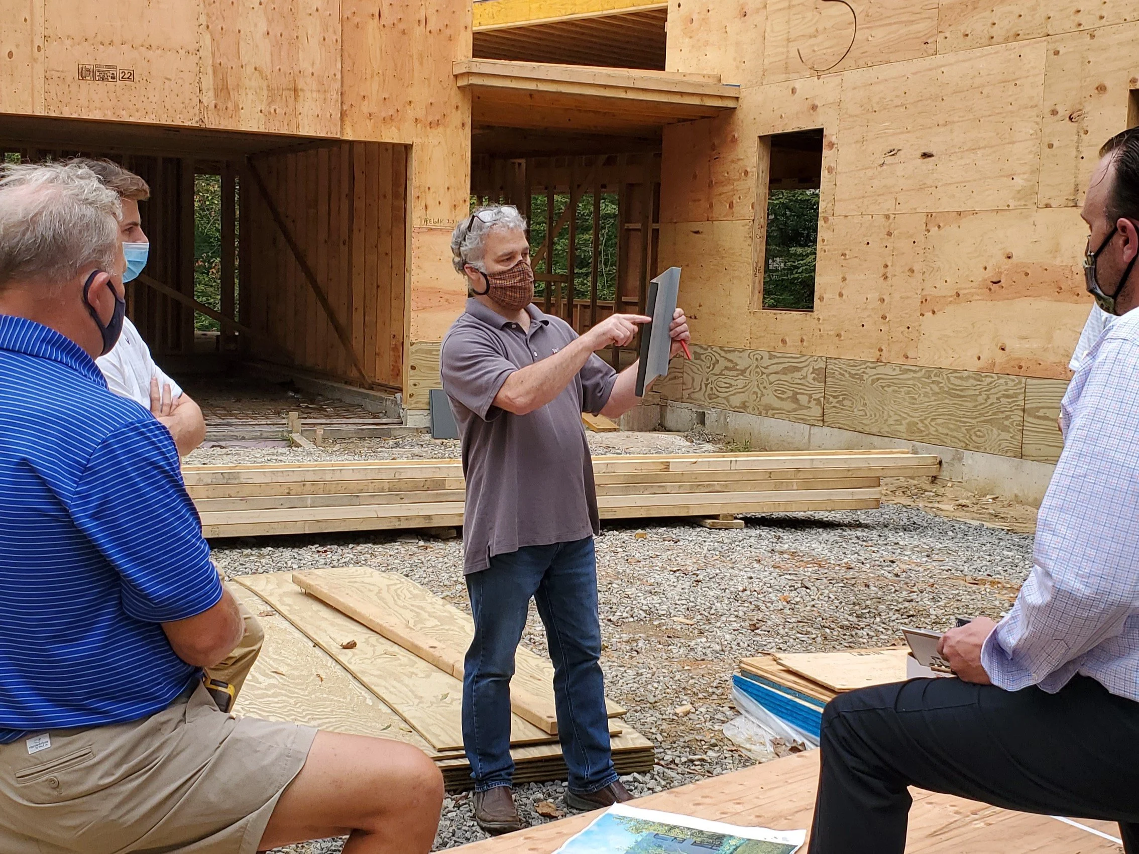 Architect Jay Reinert presenting the recyclable steel panel sample to the construction team at a masked site meeting during the pandemic, Hadro House Haddonfield NJ, September 2020