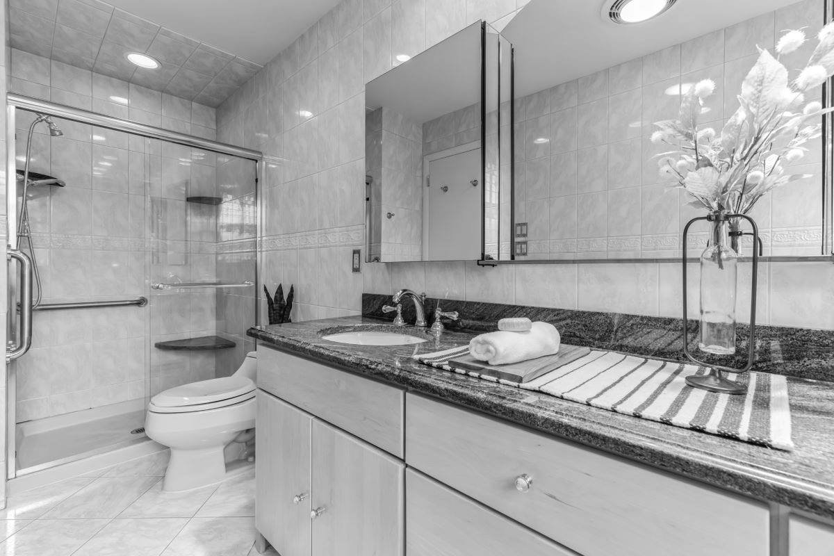 Before renovation primary bathroom mid-century modern home Cherry Hill NJ — dated tile vanity shower enclosure inadequate layout no yard connection 1964