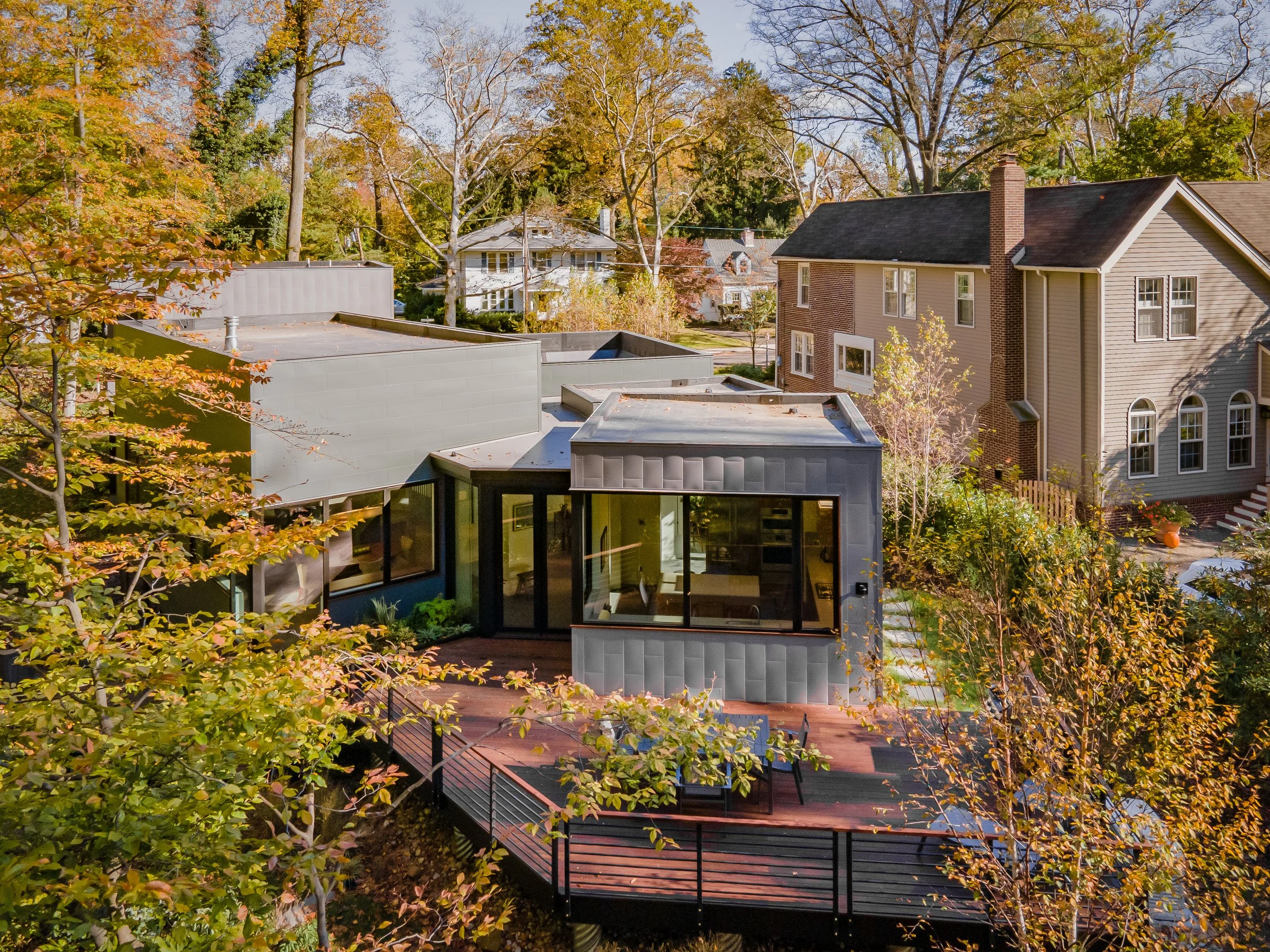 Aerial photo of Hadro House among its traditional Haddonfield NJ neighbors in fall — a contemporary custom home continuing the neighborhood's timeline of architectural styles
