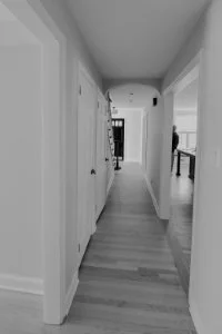 Before photo of the entry hall in a Haddonfield, NJ center hall colonial renovation showing the narrow circulation corridor, existing doorways, and limited connection between rooms.