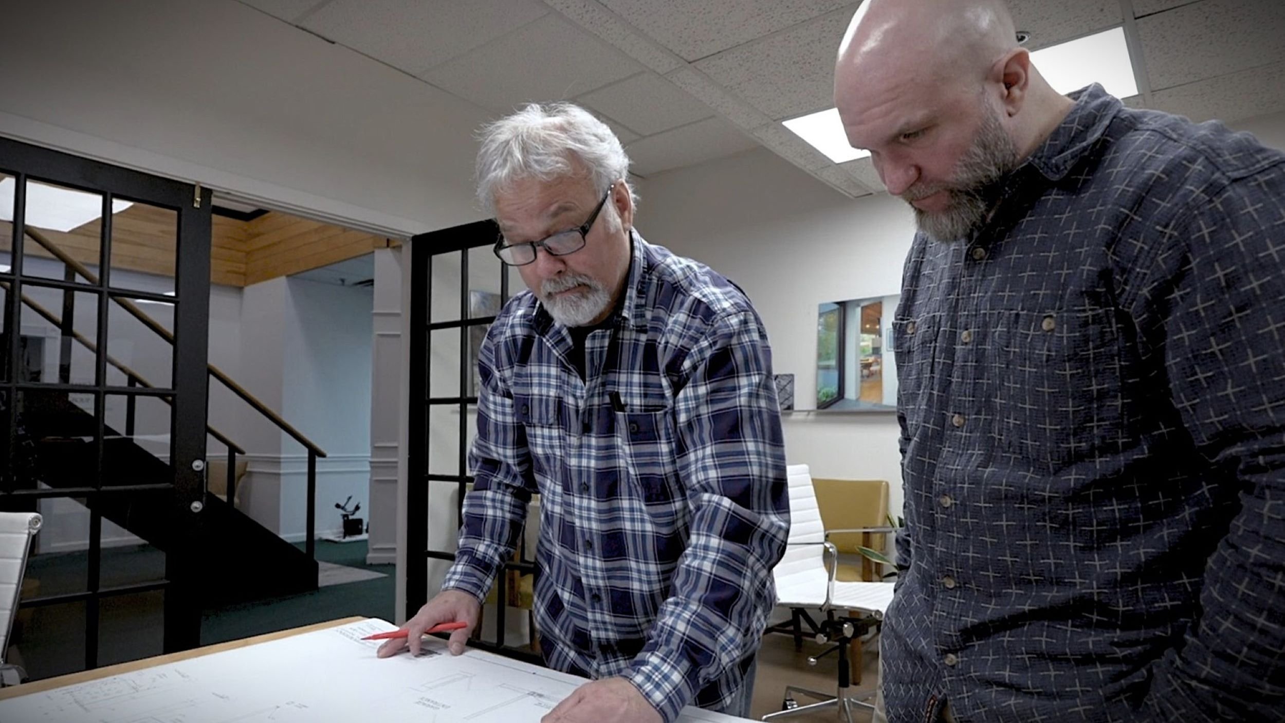Jay Reinert reviewing residential architectural drawings with a project collaborator during the design process in New Jersey.