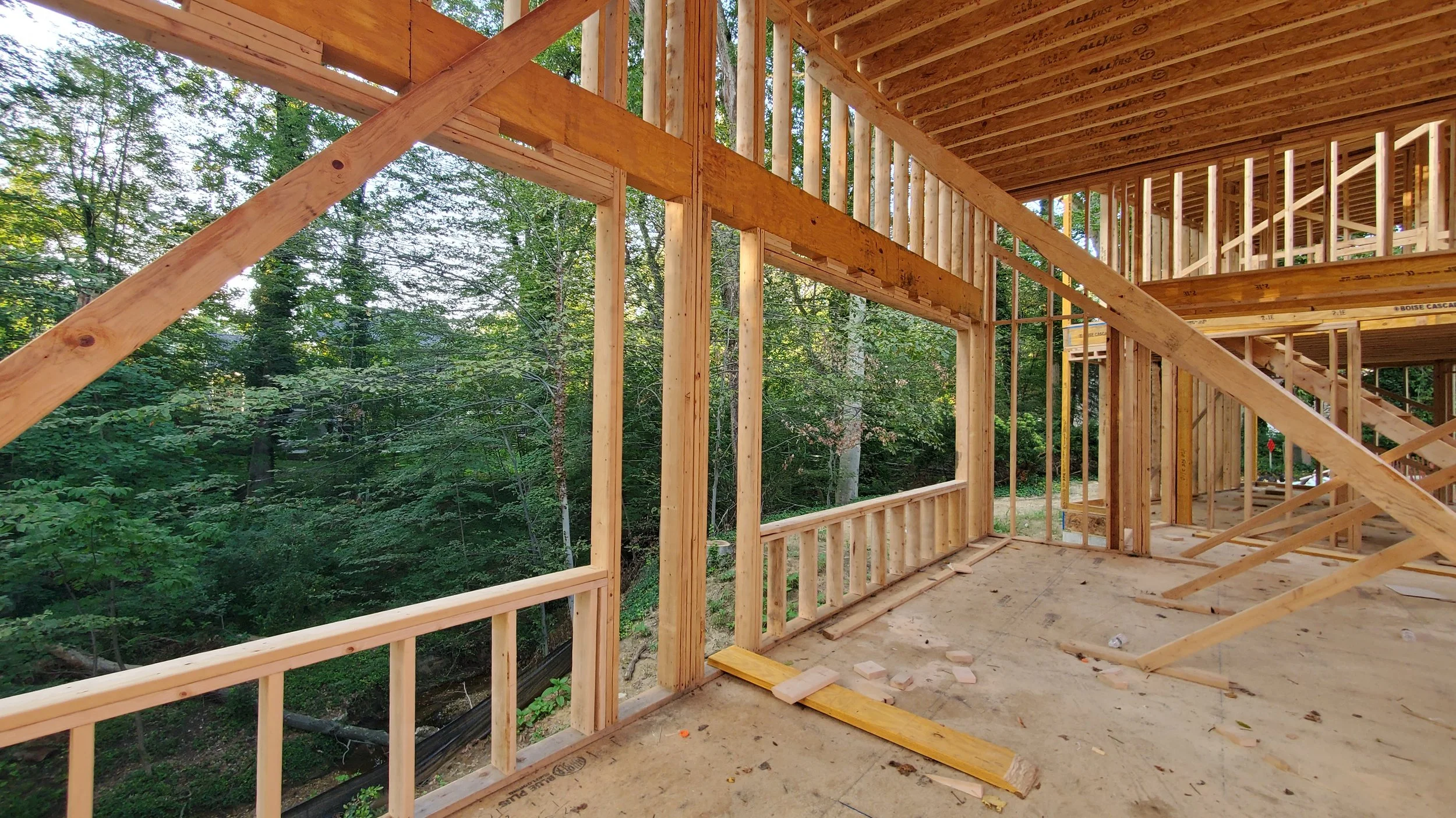 Framed window wall opening at Hadro House Haddonfield NJ during construction, August 2020 — the future north-facing glass looking into the woods above the stream