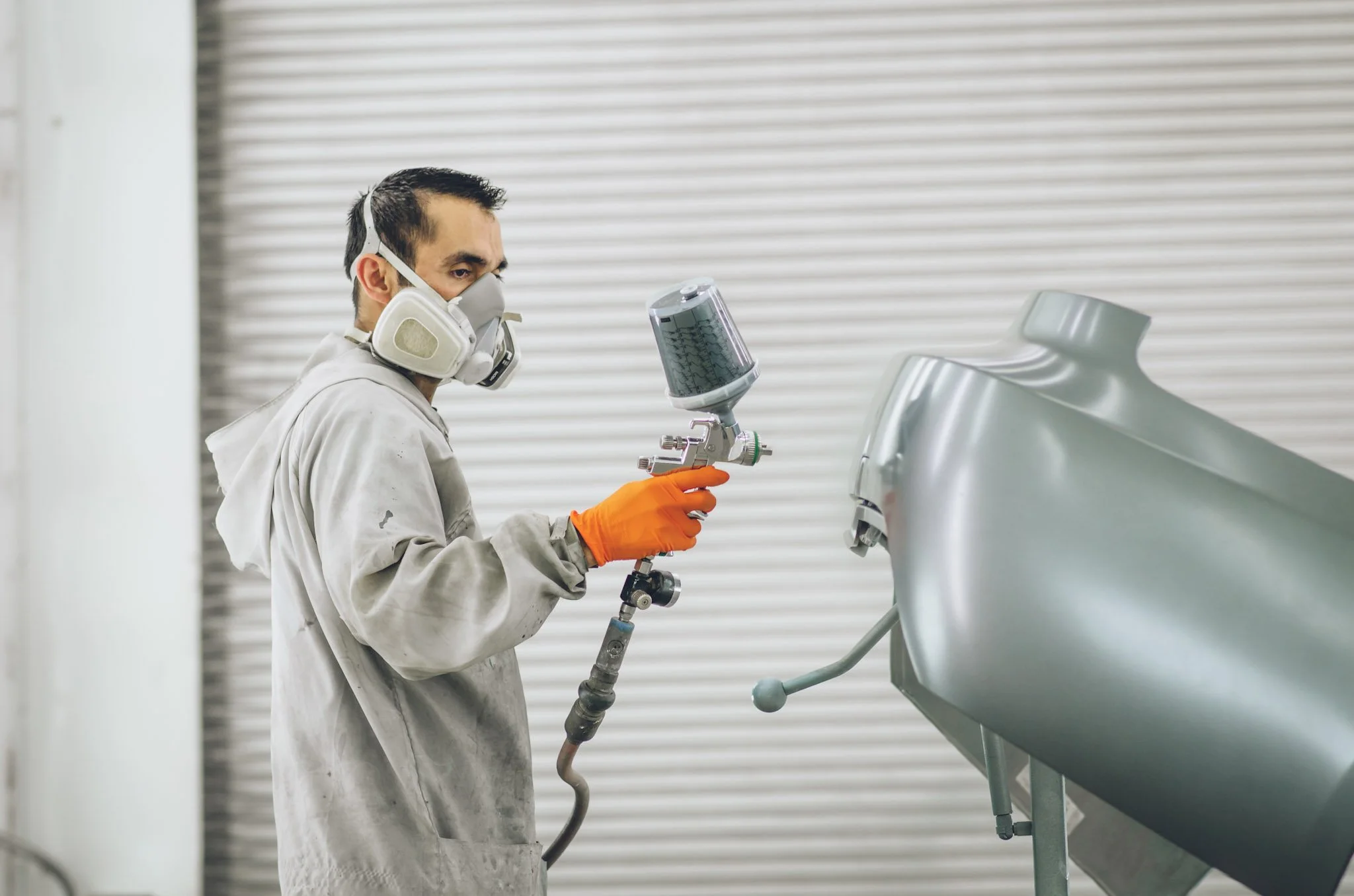 professional auto body painter in Pasco painting a fender