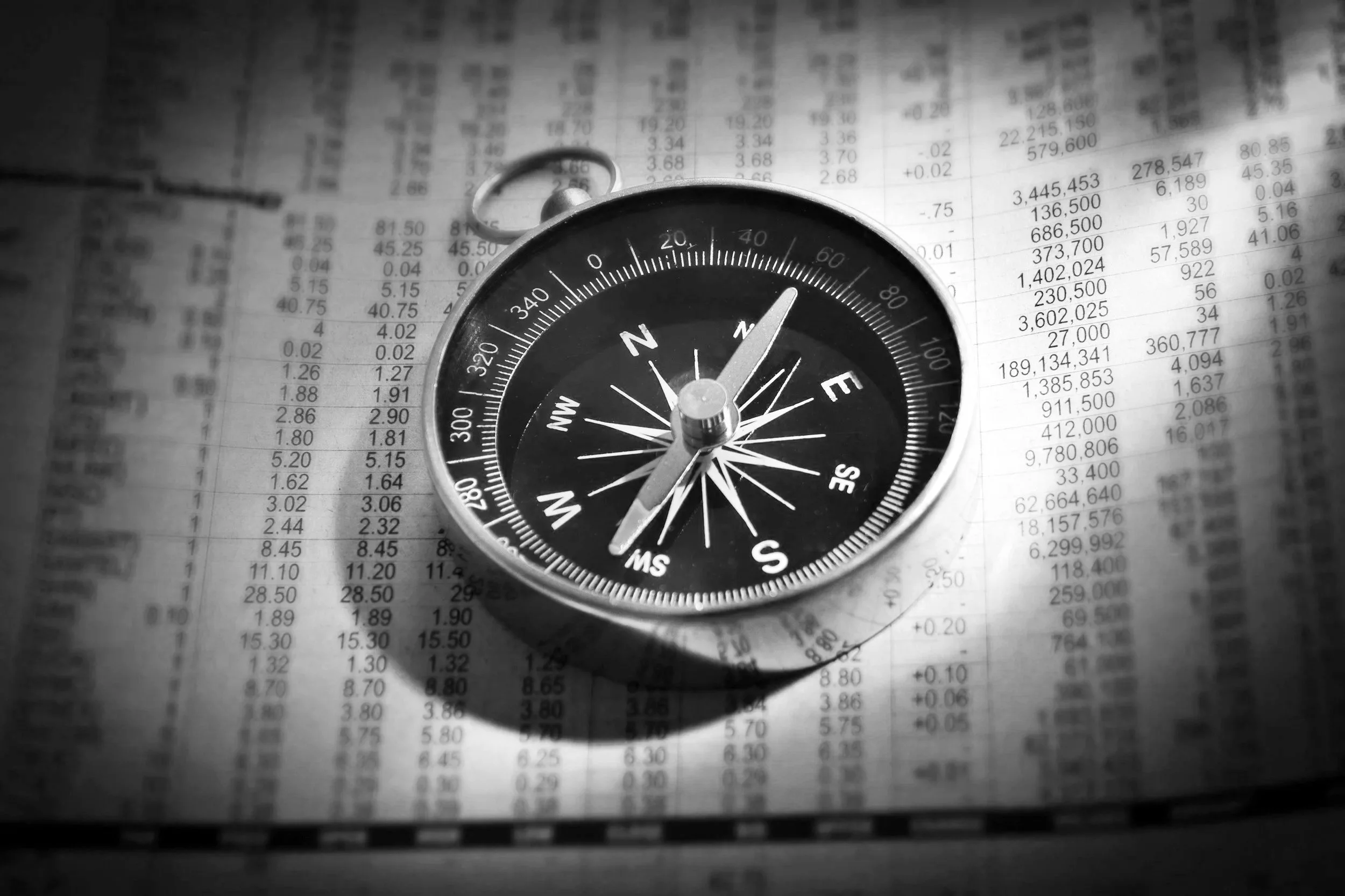 Compass on financial documents representing focused direction and operational planning for law firms.