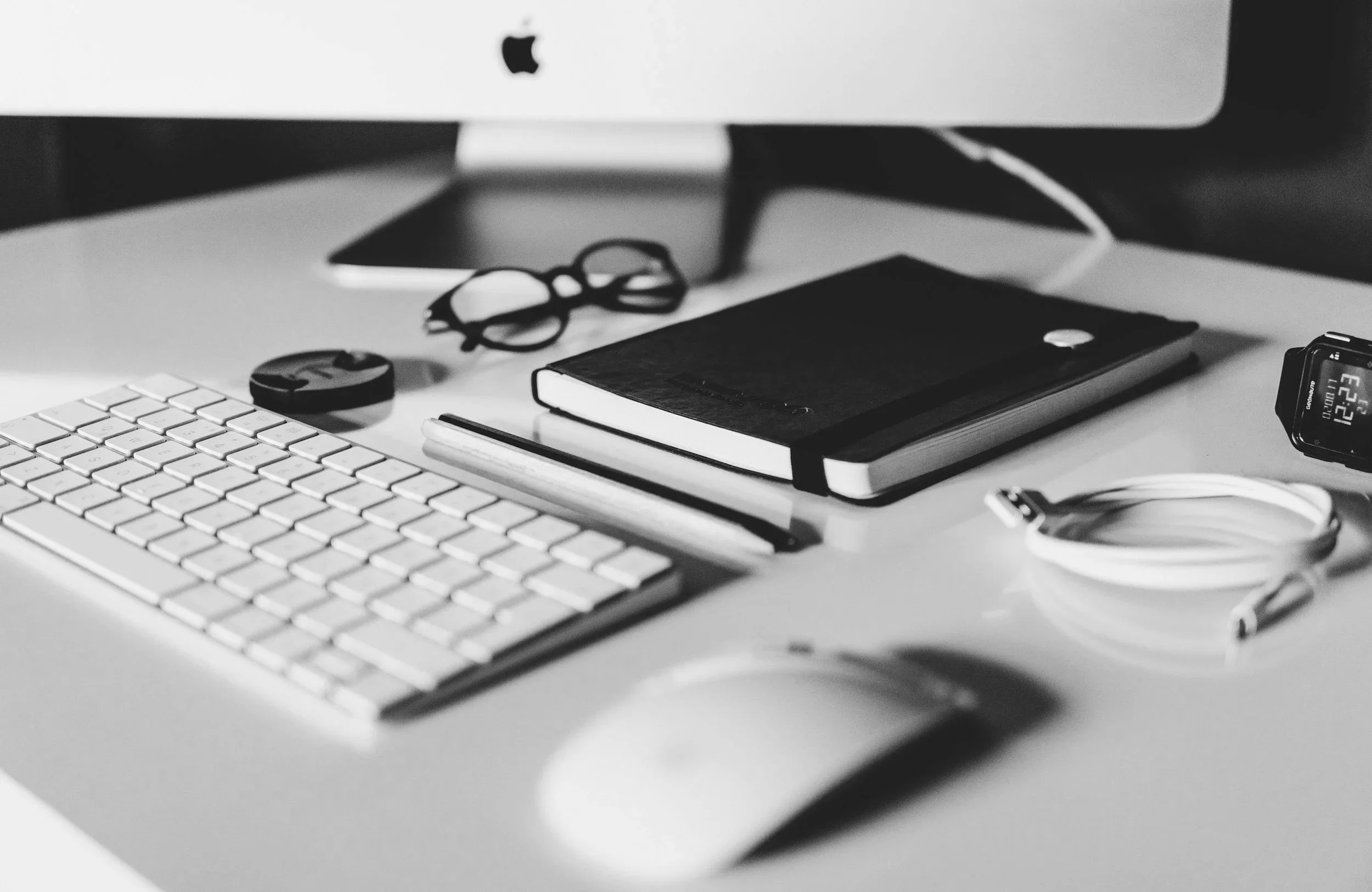 Modern legal operations workspace with technology, planning materials, and an organized professional desk setup.
