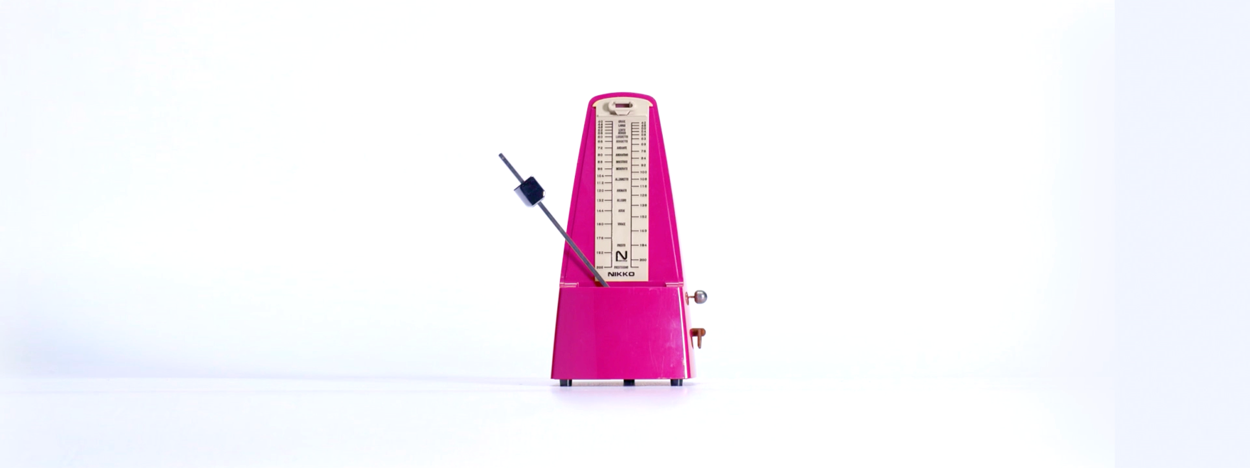 Pink metronome isolated against white, used within Survivor NZ’s pseudo-scientific experimental world.