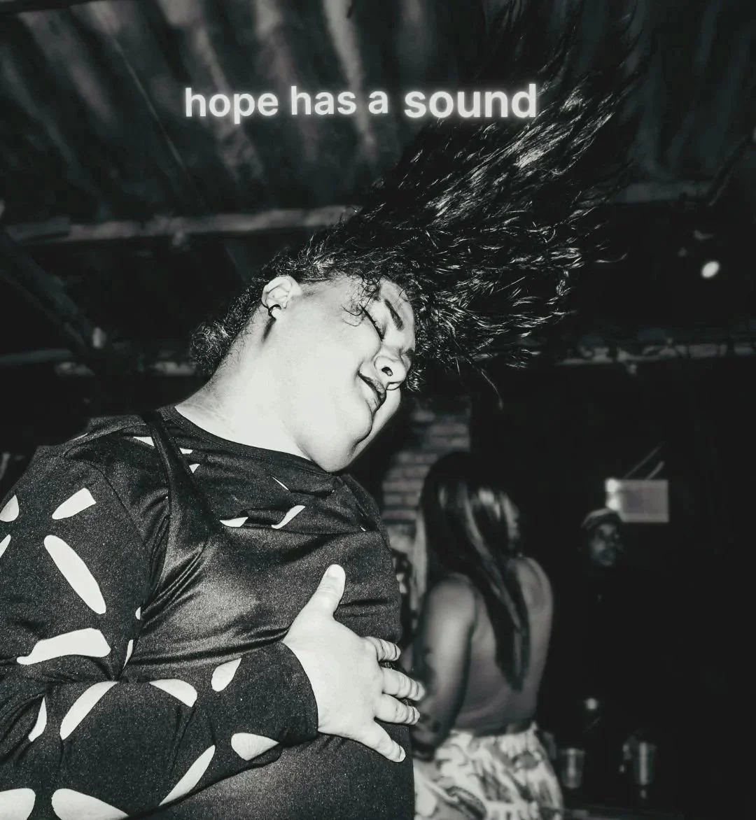 lack-and-white Youthline image of a young person in an unposed moment, dancing, beneath the words “hope has a sound”.