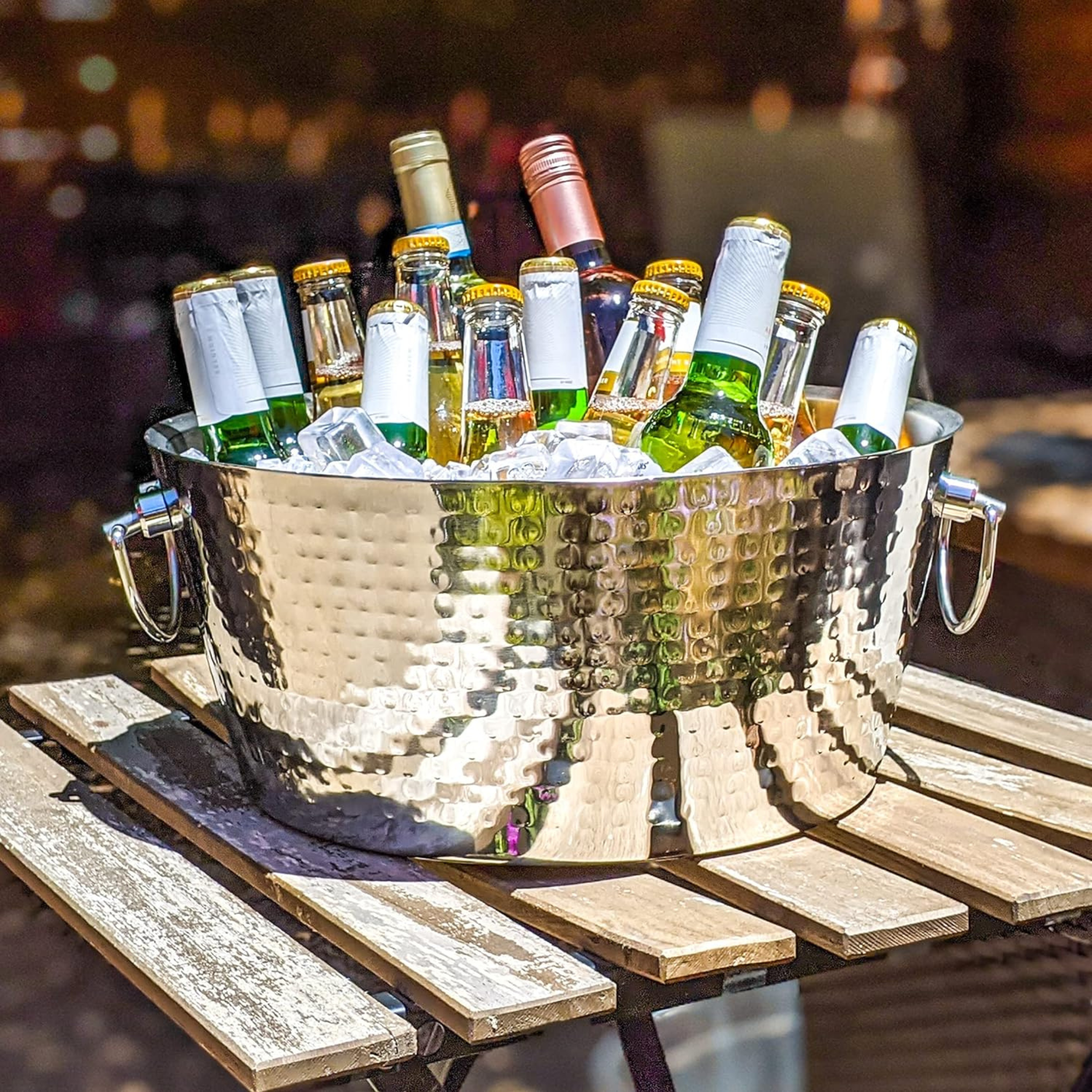 Hammered stainless steel beverage tub with ice and drinks for outdoor hosting