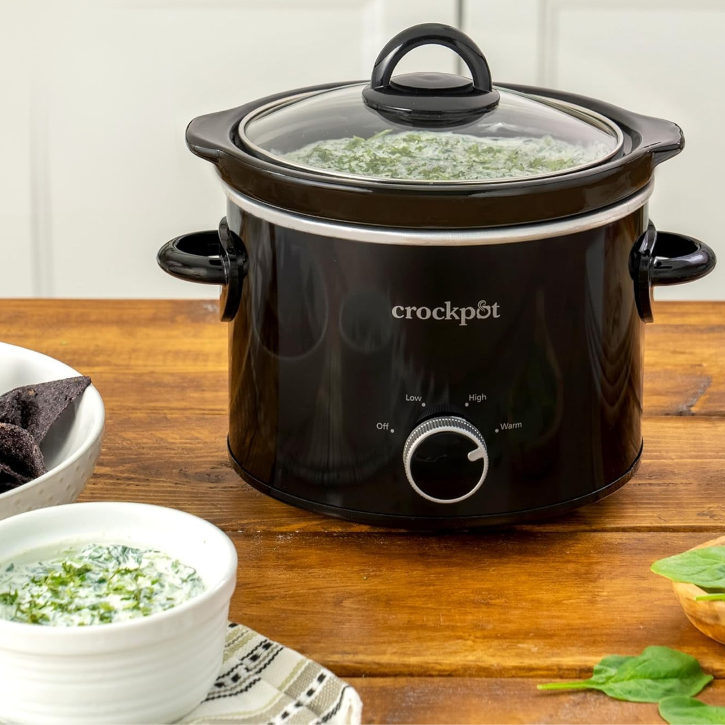 Crock-Pot mini slow cooker on wood surface for keeping dips warm