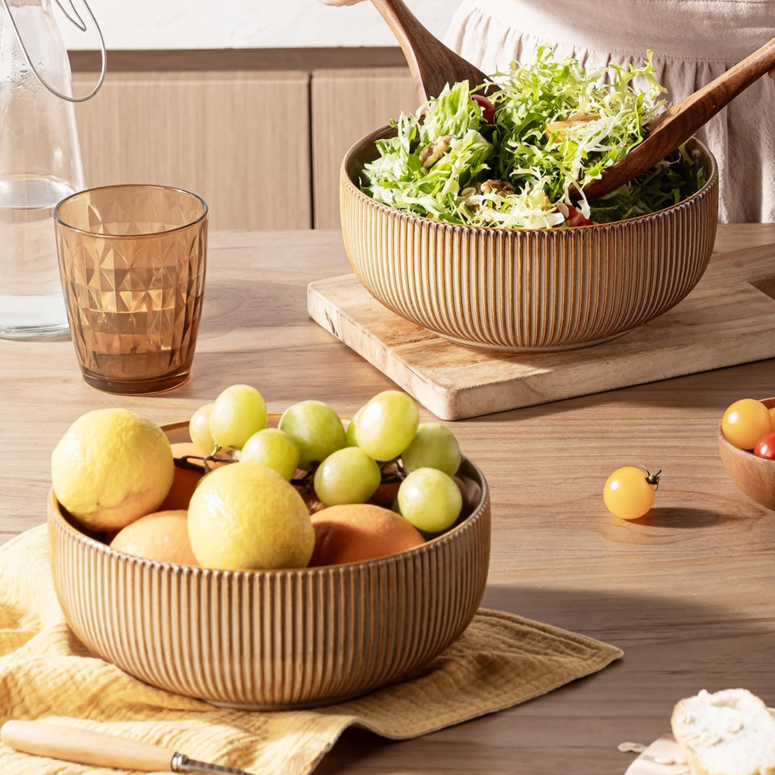 Large ribbed ceramic serving bowls in warm tan for summer entertaining